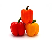 Three sweet peppers of yellow, red and orange color on a light background. Natural product. Natural color. Close-up. [dump] =>