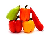 Composition of several types of sweet pepper of different shapes, colors and sizes on a light background. Natural product. Natural color. Close-up.