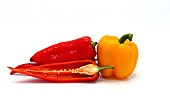 Composition of several sweet peppers and their halves of different colors on a light background. Natural product. Natural color. Close-up.