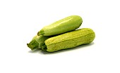 Three zucchini on a light background. Natural product. Natural color. Close-up.