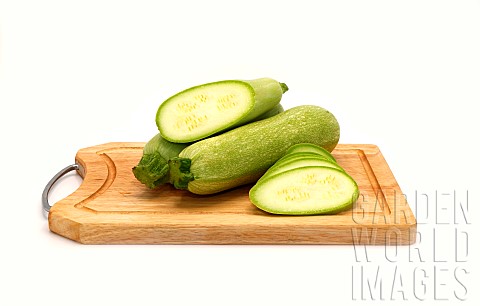 Whole_and_cut_zucchini_on_a_cutting_board_on_a_light_background_Natural_product_Natural_color_Closeu