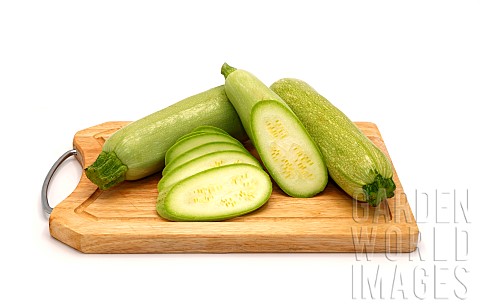 Whole_and_cut_zucchini_on_a_cutting_board_on_a_light_background_Natural_product_Natural_color_Closeu