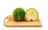 Sliced head of cabbage on a cutting board on a light background. Natural product. Natural color. Close-up.