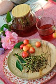 Cherry tails tea in a teapot and glass cup. Medicinal properties: vitamins C and E, antioxidant, appetite suppressant and potassium