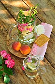 Refreshing mint drink (Mentha spicata) in a carafe with rose petals (Rosa sp) and lemon (Citrus limon), virtues, Wellness break