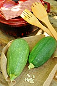 Courgettes (Cucurbita pepo) and Bolognese courgette seeds from the Kokopelli association, wooden kitchen utensils