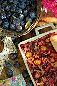 Plum harvest in a basket and plum clafoutis