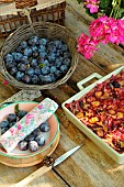 Plum harvest in a basket and plum clafoutis