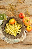 Butter beans (Phaseolus vulgaris) and apples from the garden, harvested from the vegetable garden and orchard in late summer