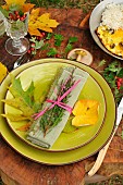 Autumn meal: Mushroom omelette, autumn table decoration with dead leaves, hawthorn cenelles, heather on a napkin and Boletus sp mushroom