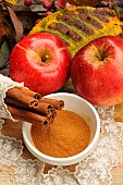 Cinnamon peel and powder and red apple