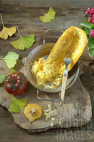 Spaghetti_squash_Cucurbita_pepo_and_seeds_in_preparation_for_cooking_and_Tomato_Solanum_lycopersicum