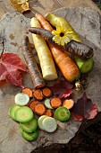 Rainbow carrots (Daucus carota) on a wooden cutting board