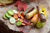 Rainbow carrots (Daucus carota) on a wooden cutting board