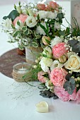 Table bouquet, Rose (Rosa sp), Gypsophila (Gypsophila paniculata), romantic atmosphere, heart-shaped candle and ribbon bow