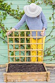 Woman setting up a mini vegetable garden on a terrace step by step.