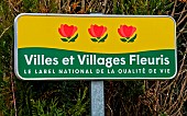 Village entrance sign Villes et Villages Fleuris, le label national de la qualité de vie, Three flowers for the village of Savigné-lEvêque, Sarthe, Pays de la Loire, France.