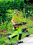 City gardener planting flowers in a flowerbed at Parc de Tesse, public garden, Le Mans, Sarthe, Pays de la Loire, France