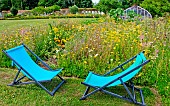 Relaxation in the vegetable garden, two deckchairs next to several varieties of flowers, Relaxation area in the vegetable garden at Bonnétable, Sarthe, France