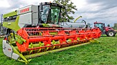Very modern combine harvester for wheat harvesting from Claas and a tractor and tank for slurry spreading, Sarthe, France