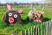 Straw-bale pig and cow in a field at larche de la nature, Le Mans, Sarthe, France