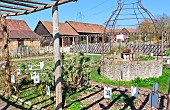 Future garden flowers and the Arche de la Nature well in spring, Le Mans metropole, Sarthe, France
