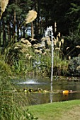 Pond bordered with Cortaderia argentea and water fountain jet, Mellerstain Garden