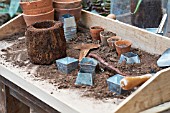 POTTING TOOLS ON A WOODEN TABLE