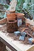 POTTING TOOLS ON A WOODEN TABLE