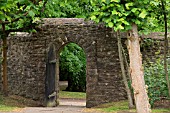 VISTA THROUGH A GARDEN WALL DOOR AT ST FAGANS CASTLE GARDENS