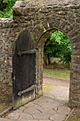 VISTA THROUGH A GARDEN WALL DOOR AT ST FAGANS CASTLE GARDENS