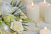 FLOWER ARRANGEMENT WITH WHITE ROSES, EUSTOMIA, LYSIANTHUS, CANDLES AND PEARLS