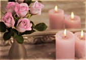 PINK ROSES AND CANDLES IN FRONT OF A MIRROR