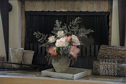 FLOWER_ARRANGEMENT_WITH_ROSES_IN_FRONT_OF_FIREPLACE
