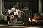 FLOWER ARRANGEMENT WITH ROSES IN FRONT OF FIREPLACE