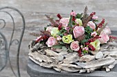 FLOWER ARRANGEMENT WITH PINK ROSES ON A WREATH OF DRIFTWOOD