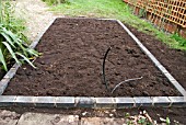 GREENHOUSE CONSTRUCTION AT WAKEFIELDS GARDEN, FOUNDATIONS BUILT, TOPSOIL ADDED.