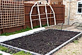 GREENHOUSE CONSTRUCTION AT WAKEFIELDS GARDEN.  SITE PREPARED, COMPONENTS NEARBY.