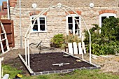 GREENHOUSE CONSTRUCTION AT WAKEFIELDS GARDEN, FIRST FRAMES ERECTED.