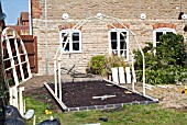 GREENHOUSE CONSTRUCTION AT WAKEFIELDS GARDEN, FIRST TWO FRAMES ERECTED.