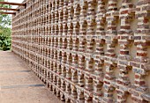 TERRA BOTANICA, OLD-STYLE DECORATIVE BRICK WALL IN TAMED GARDEN