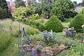 WAKEFIELDS GARDEN IN SUMMER SHOWING MEADOW AND BORDERS