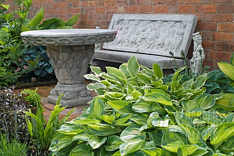 STONE_SEAT_AND_TABLE_WITH_HOSTAS_AT_WALTERS_COTTAGE