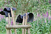 FIRE BEATERS WITH  FOXGLOVES IN A WOODLAND SETTING.