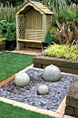 BUBBLE FOUNTAIN ON SLATE RAISED RAILWAY SLEEPER BEDS ARBOUR WITH SEAT FOLIAGE PLANTS SMALL COURTYARD TOWN GARDEN