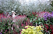 STATUE IN HERBACEOUS BORDER