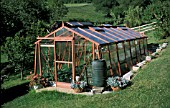 WOODEN GREENHOUSE IN GARDEN