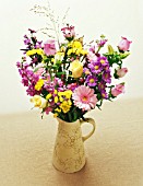 PINK AND YELLOW THEMED FLOWER ARRANGEMENT IN JUG