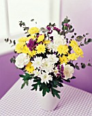 YELLOW AND WHITE FLOWERS IN WHITE VASE