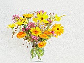 Studio shot of summer flowers in glass jar, Artistic textured layers added to image to produce a painterly effect.